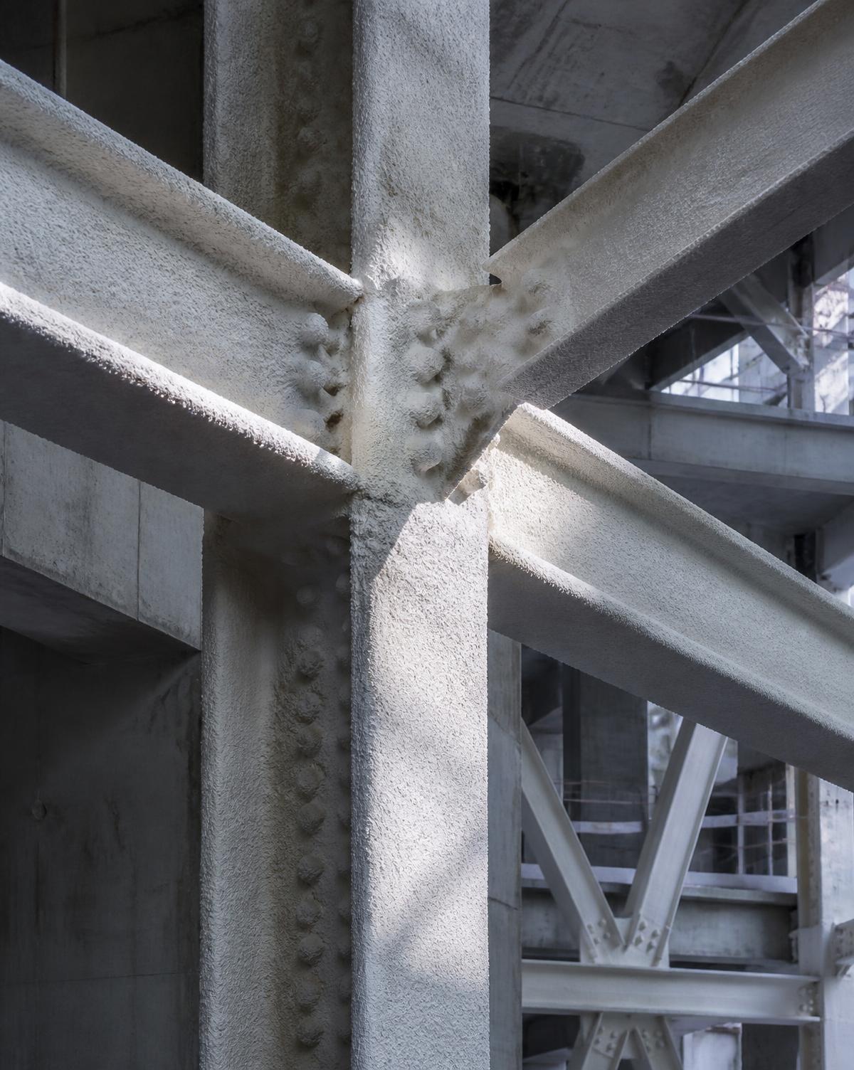 Structural steel beams coated with intumescent protection inside a commercial building core